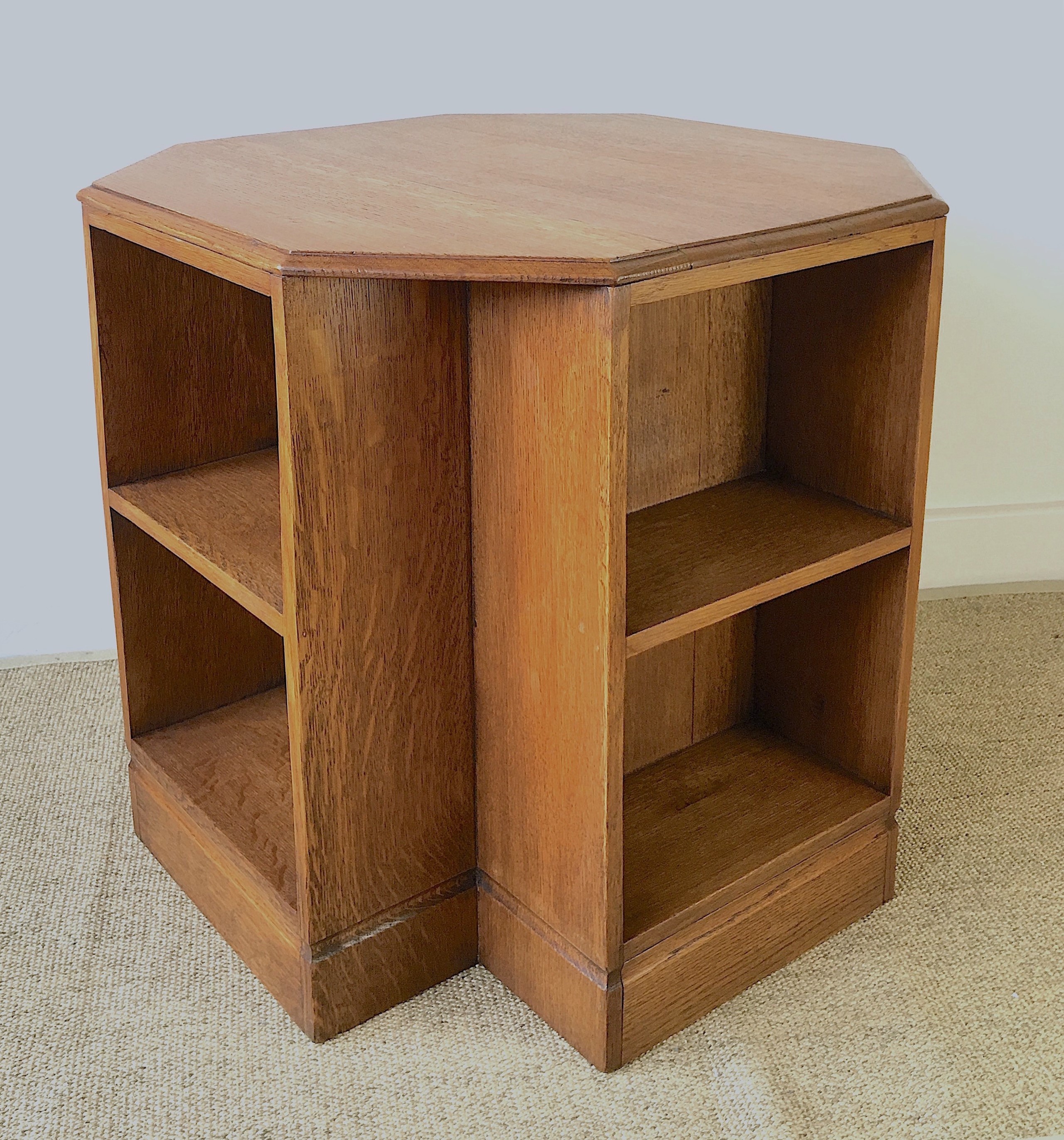 A 1930's Heals style octagonal golden oak book table, width 60cm, height 58cm